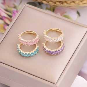 Close-up of four rectangle zircon rings in pink blue purple and white on a jewelry box