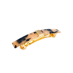 Detail view of tortoiseshell acetate hair clip with sparkling rhinestone gold buckle