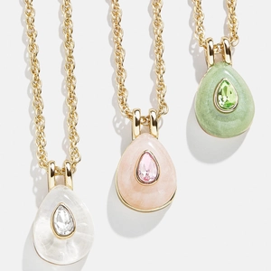 Three gold twist chain necklaces with pear-shaped white, pink, and green zircon pendants