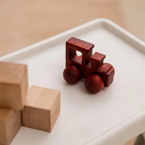 Macro shot of detailed natural wood grain on a mini walnut toy car for toddlers