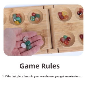 Macro shot of hand picking colorful gemstones from a foldable wooden Mancala board