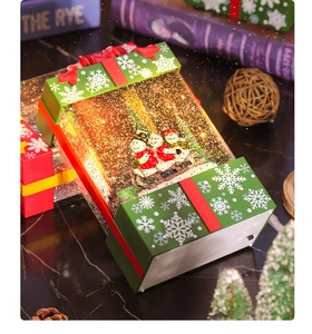 Close-up of a festive Christmas snow globe music box with LED lights and snowman inside