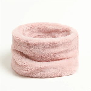 Close-up of soft pink faux rabbit fur neck warmer with plush texture and circular design