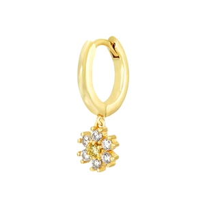 Detail of gold huggie hoop earring with a sparkling flower charm and yellow gemstone