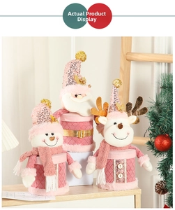 Pink Christmas doll candy jars featuring Santa, Snowman, and Reindeer on a wooden table