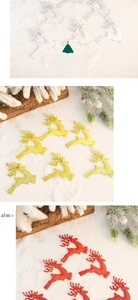 Detailed view of Christmas elk ornaments with pearl textures in white, gold, and red tones