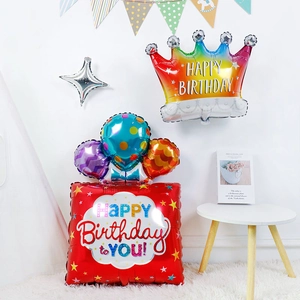 Detail of colorful crown and square foil balloons for birthday party decoration
