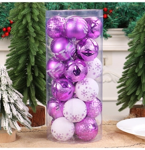 Close-up of purple and white decorative Christmas ball ornaments set in a clear cylinder