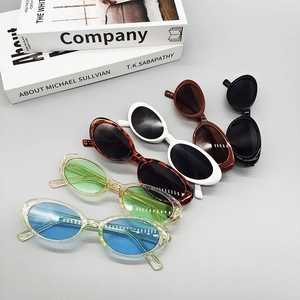 Group of retro oval sunglasses in multiple colors displayed in a diagonal layout