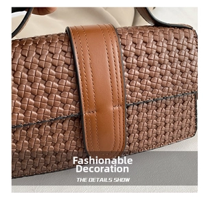 Detailed view of brown woven texture on a faux leather crossbody bag with stitching