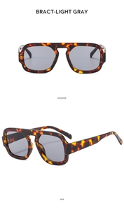 Detail view of square oversized sunglasses with tortoise shell frame and light gray lenses