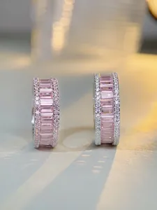 Macro detail of luxury S925 silver hoop earrings with pink square-cut gemstones
