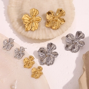 Detailed close-up of 18K gold and silver plated five-petal flower stud earrings