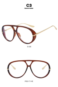 Detail view of oversized retro aviator sunglasses with amber resin frames and gold temples