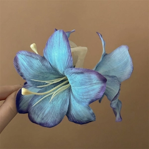 Detailed view of the purple lily hair claw clip with natural fabric petals and yellow stamen
