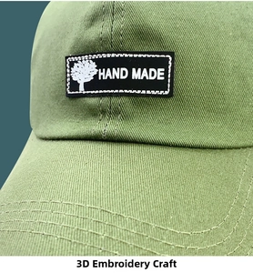 Detail of green cotton baseball cap showing 3D hand-made embroidery and fine stitching