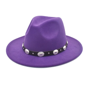Detail of vintage metal buckle and silver rivets on a purple wool fedora hat