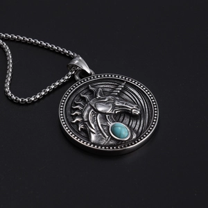 Detailed side view of vintage unicorn relief pendant with turquoise gemstone on box chain
