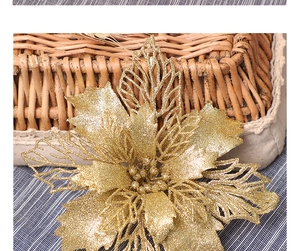 Detail of glittery gold artificial Christmas flower on a rustic woven basket