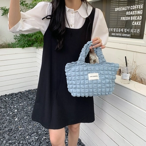 Close-up of light blue bubble textured tote bag with LOVE SOZAKKA woven label