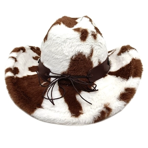 Detailed texture of cow print faux fur on a western cowboy hat with a leather decorative band
