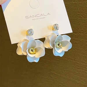 Elegant white camellia flower earrings with zircon stud on brand card display