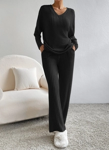 Close-up of black ribbed knit lounge set featuring V-neck long sleeve top and wide-leg pants