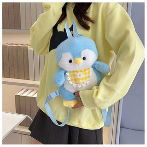 Detailed view of the cute blue plush penguin backpack with a yellow checkered bib