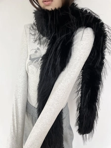 Detail of soft black faux fur scarf showing premium plush texture and long design