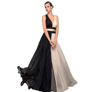 Detail of elegant V-neck sleeveless color-block maxi dress with flowing pleated skirt