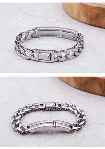 Detail of men's titanium steel bracelet with engraved cross and inlaid diamonds
