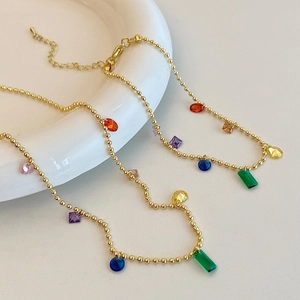 Elegant gold bead necklace with geometric colorful gemstones and lobster clasp design