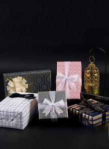Detail of luxury gold-foil patterns on premium black checkered gift wrapping paper rolls