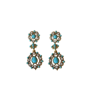 Vintage gold drop earrings with turquoise stone and white pearls on white background