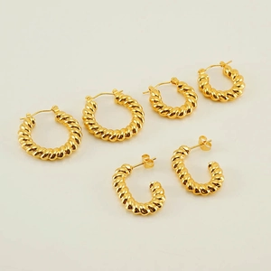 Three-pair set of gold twisted rope hoop earrings and C-shaped studs in polished metal