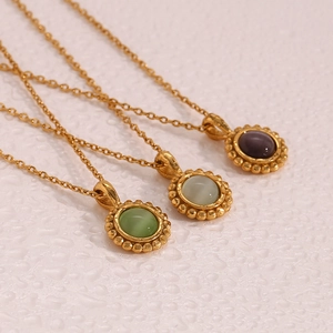 Detailed close-up of retro stainless steel sun necklaces with colorful stone pendants