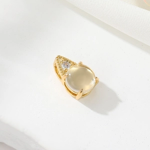 Macro view of 14K gold plated pendant featuring a yellow gemstone with milgrain detail
