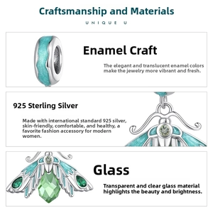 Macro detail of S925 silver moth charm with blue enamel wings and green glass inlay
