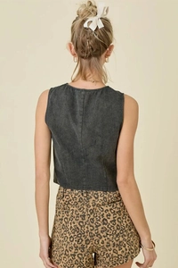 Rear view of dark grey denim vest and leopard print shorts showing texture and fit
