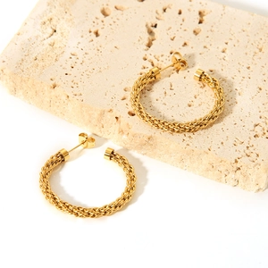 18K gold plated stainless steel C-shaped twisted hoop earrings on stone display