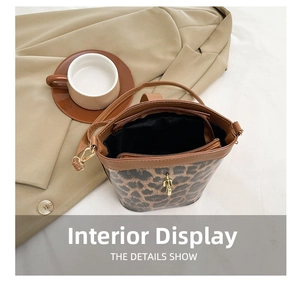 Top view showing leopard bucket bag interior with compartments and gold hardware