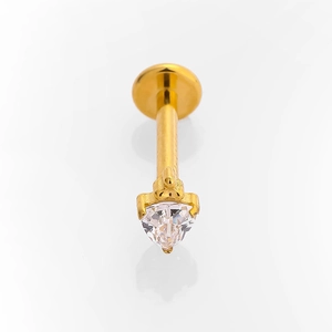 Macro shot of gold G23 titanium labret stud with a heart-shaped clear zircon stone