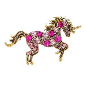Vintage gold unicorn brooch with sparkling pink and clear crystals on a white background