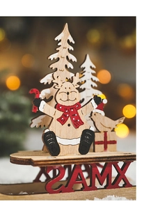 Macro detail of wooden Christmas ornament with XMAS cutout and warm festive background lighting