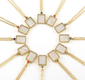 Detailed circular arrangement of twelve golden birthstone necklaces with shell pendants