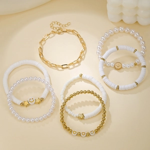 Close-up of bohemian multi-layered beaded bracelets with smiley face and pearl charms