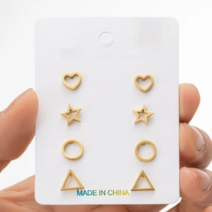 Set of 4 pairs of gold stainless steel geometric stud earrings on a display card