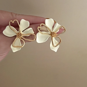 Elegant double-layer hollow flower stud earrings in cream white and gold metal finish