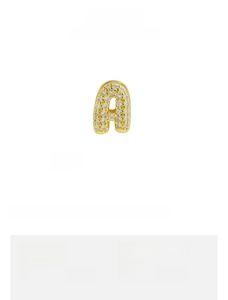 Macro shot of a 9.3x6.6mm gold brass letter a pendant with zircon pave setting
