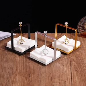 Creative metal napkin holder set in gold, silver, and black finishes with crystal weighted arm